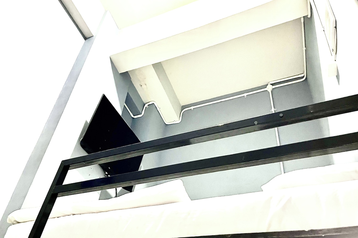 A part of a building with a white exterior and metal railings.