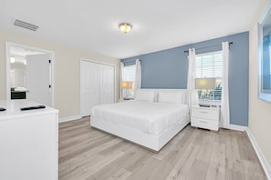 A bedroom with a bed, bedside tables, a dresser, and a window with curtains. - Marvel | Mickey | Splash Pool | 4 Miles Disney 4876 (Kissimmee)