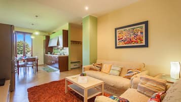Family Apartment, 2 Bedrooms, Balcony (Happy Apartment Nettuno Close To Sea) | Living area | Flat-screen TV