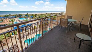 A balcony with a view of a beach and a pool area. - Coastal Retreat 3 Bedroom Oceanfront 4th Floor (North Myrtle Beach)