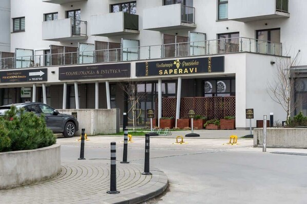 A building with a sign for 'Saperavi' restaurant and 'Kosmetologia & Estetyk' spa.