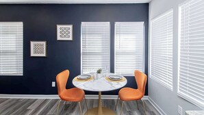 A dining area with a round table, two chairs, and a ceiling light fixture. - Luxury Studio, 3-Min Walk to Oaklawn Casino (Hot Springs)