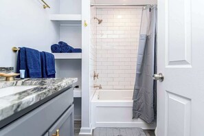 Shower, hair dryer, towels, shampoo