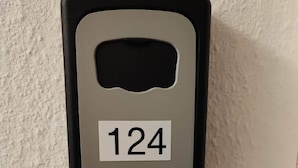 A wall-mounted device with the number 124 on it.