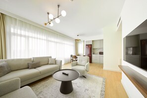 A modern living room with a sofa, a coffee table, and a TV. - The Marmara Çamlıca (Istanbul)
