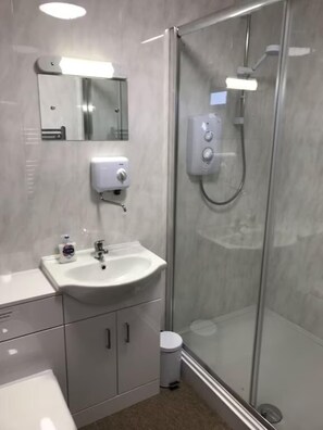 Regadera, toallas, papel de baño