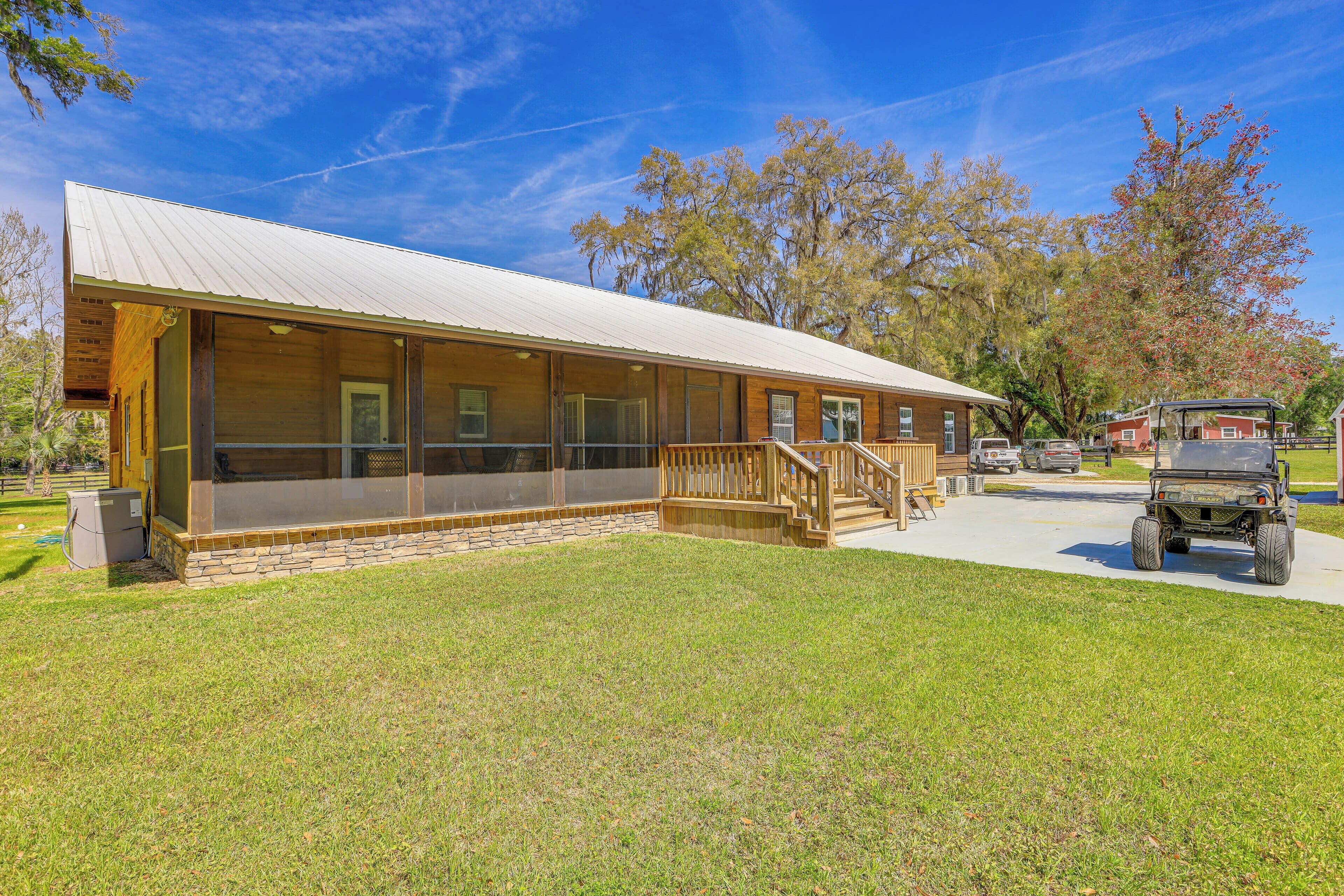 A single-story building with a covered porch and a stone foundation.