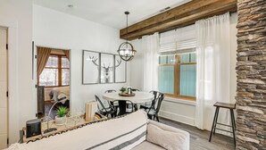 A dining area with a round table, chairs, and a hanging light fixture. - Dtwn Blowing Rock Condo w/ Private Hot Tub! (Blowing Rock)