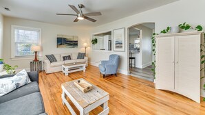 A living room with a sofa, armchair, coffee table, and a ceiling fan. - New Bern House w/ Gas Grill Near Neuse River! (New Bern)