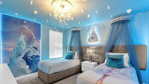 A bedroom with two beds, a chandelier, and a mural of a castle. - Upstay 9BR Villa w Pool & Cinema—Epic Universe (Championsgate)