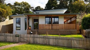 A modern two-story house with a covered porch, a fenced yard, and a mailbox. - Wynvale Cottage @ Hepburn (Hepburn)