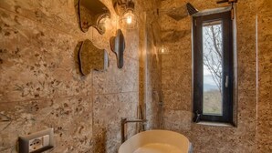A bathroom with a large, round sink, a shower, and a window with a view of trees. - PaterMater b&b - Lana Room (Castell'Azzara)