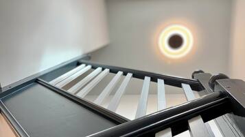 A close-up of a sliding door with a circular light fixture above it.