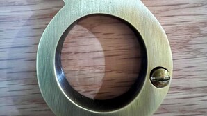 A brass number eight door knocker on a wooden surface. - The Bath Rooms (Morecambe)