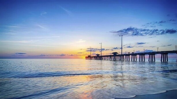 A pier extending into calm waters at sunset. - Coral Shores Resort (North Redington Beach)
