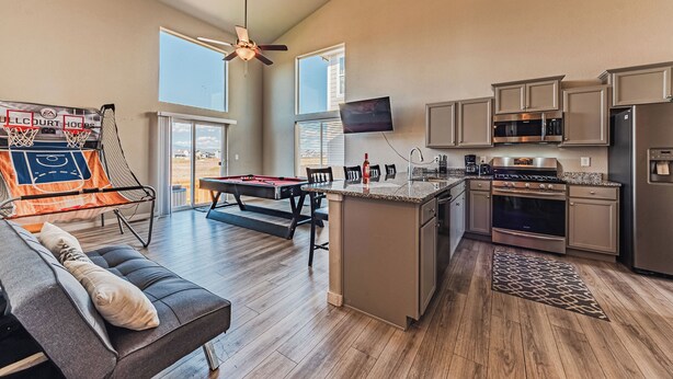 A spacious living area with a pool table, a sofa, and a ceiling fan. - •Wacissa Lookout View - Wine, GameRoom, HotTub• (Colorado Springs)
