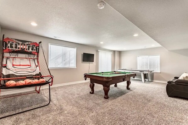 A recreational room with a pool table, a ping pong table, and a basketball hoop. - •Estates at Volga Dr• GameRoom, Wine & HotTub (Colorado Springs)
