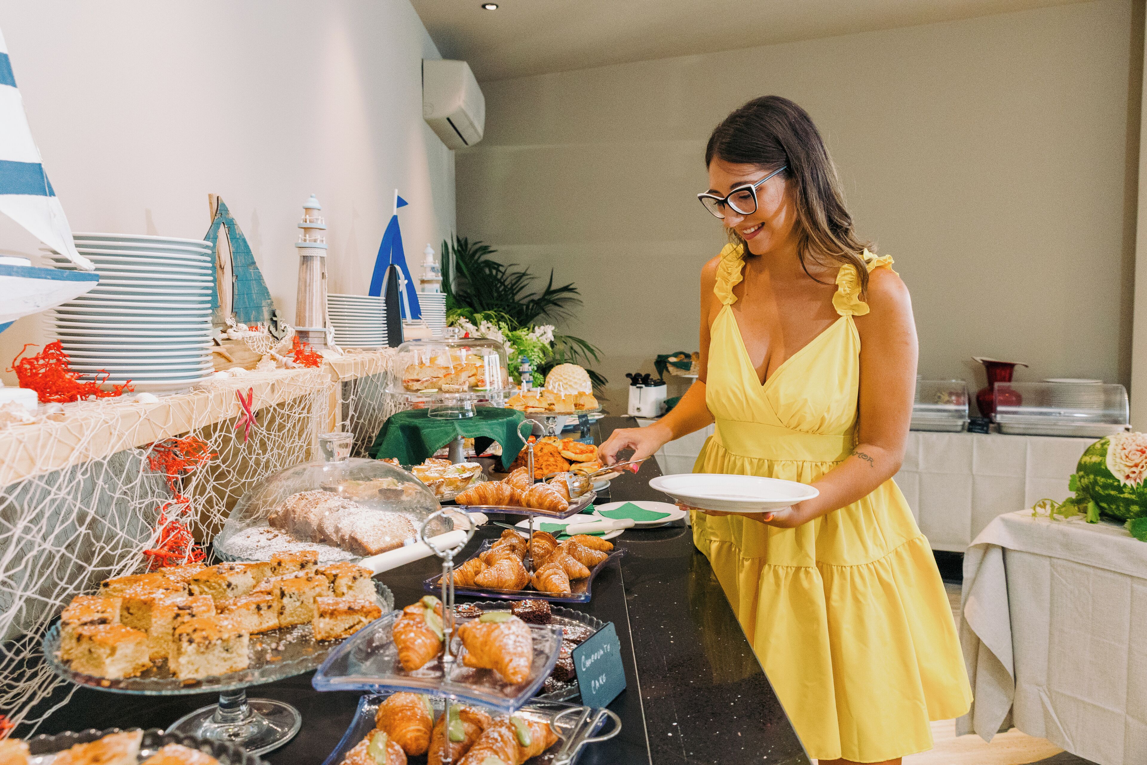 A buffet with various food items and a person serving.