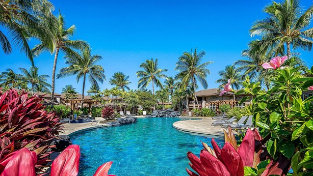 A resort pool surrounded by palm trees and tropical plants. - Colony Villas Waikoloa 301 (Waikoloa)