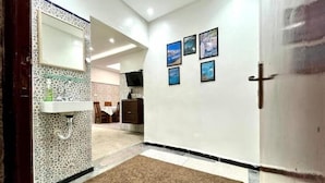 A hotel room with a bathroom, a dining area, and a living space. - Maison Calme à Proximité de la mer (Agadir)