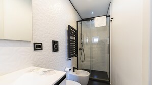 A modern bathroom with a white vanity, a glass shower enclosure, and a towel rack. - Via Concezione a Montecalvario 19 - Camera 1 (Naples)