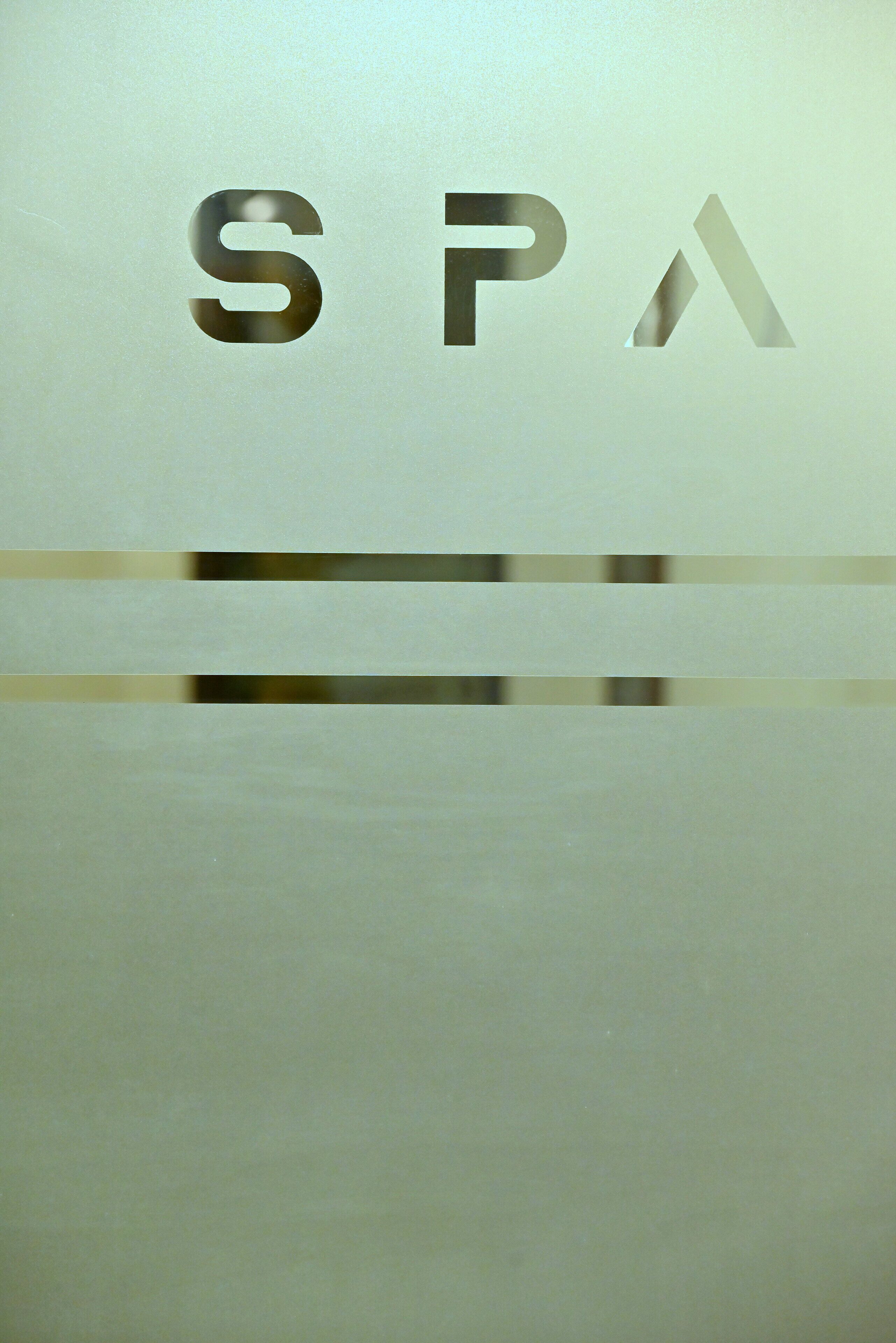 A frosted glass sign with the letters "SPA" visible.