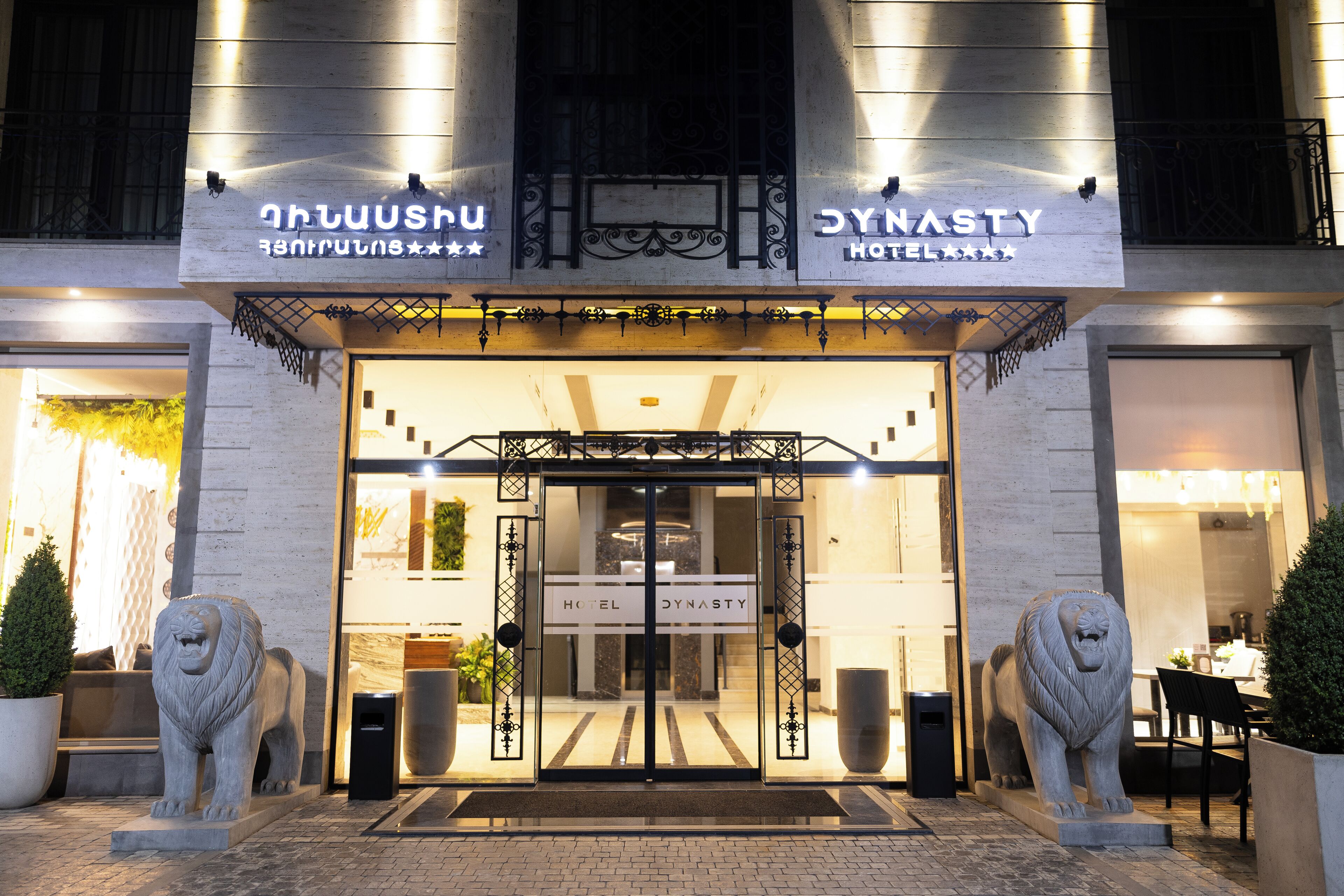 The entrance to the Hotel Dynasty with a lion statue on either side.
