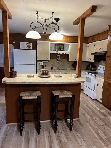 Charming country home, game room, pond, gazebo and peaceful sounds of windmill. 