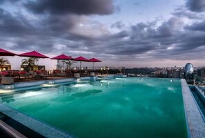Relax by the rooftop pool with a stunning city view.