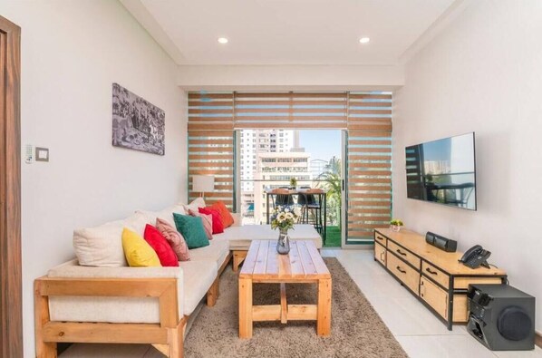 Relax in this stylish living room with a sofa, coffee table, flat-screen TV, and cabinet.