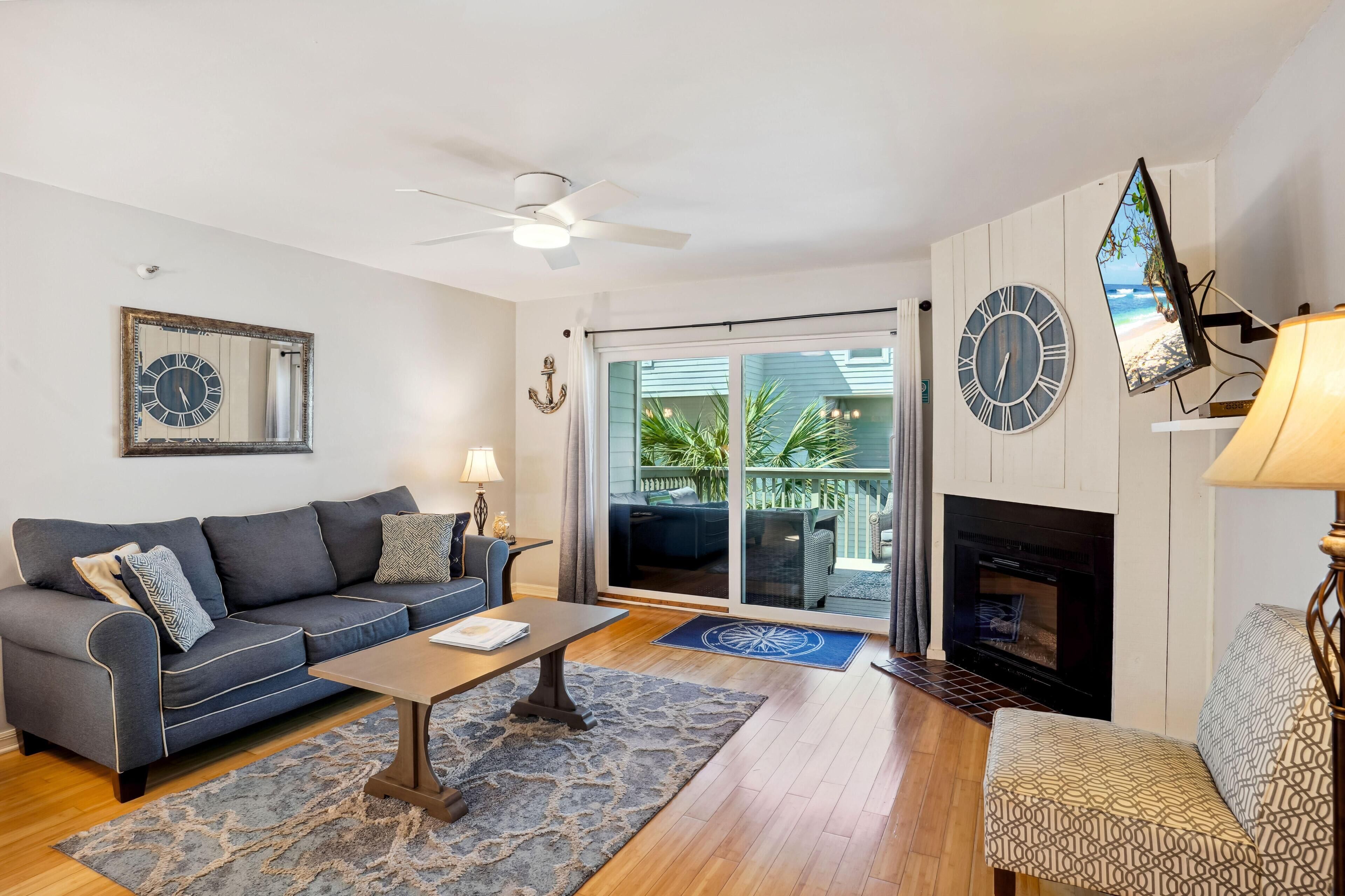 A living room with a sofa, coffee table, and fireplace.