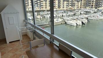 A balcony with a view of a marina and residential buildings.