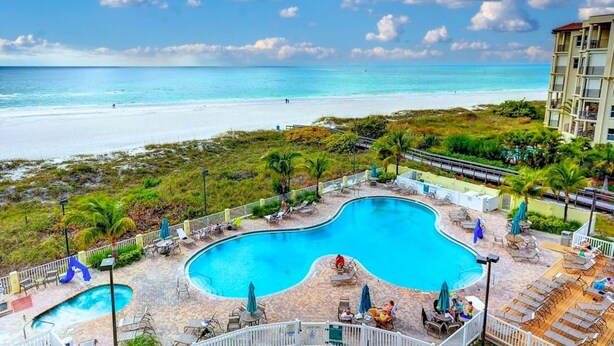 A resort with a large pool, beach access, and a view of the ocean. - Sunset Vistas 211n (Treasure Island)