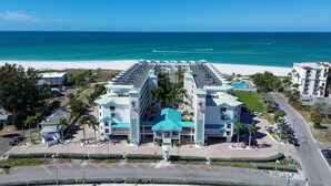 A hotel with a central courtyard, multiple floors, and a view of the beach and ocean. - Sunset Vistas 211n (Treasure Island)