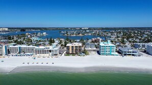 A coastal hotel with multiple buildings, a beach, and a marina. - Trillium 2A - Premier (Madeira Beach)