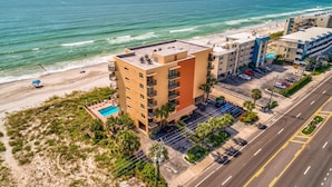 A coastal hotel with multiple floors, a rooftop pool, and a beach view. - Trillium 2A - Premier (Madeira Beach)