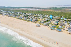 A coastal residential area with houses, a beach, and a body of water. - Oceanside home in South Nags Head just 250 ft to the beach!! (South Nags Head)