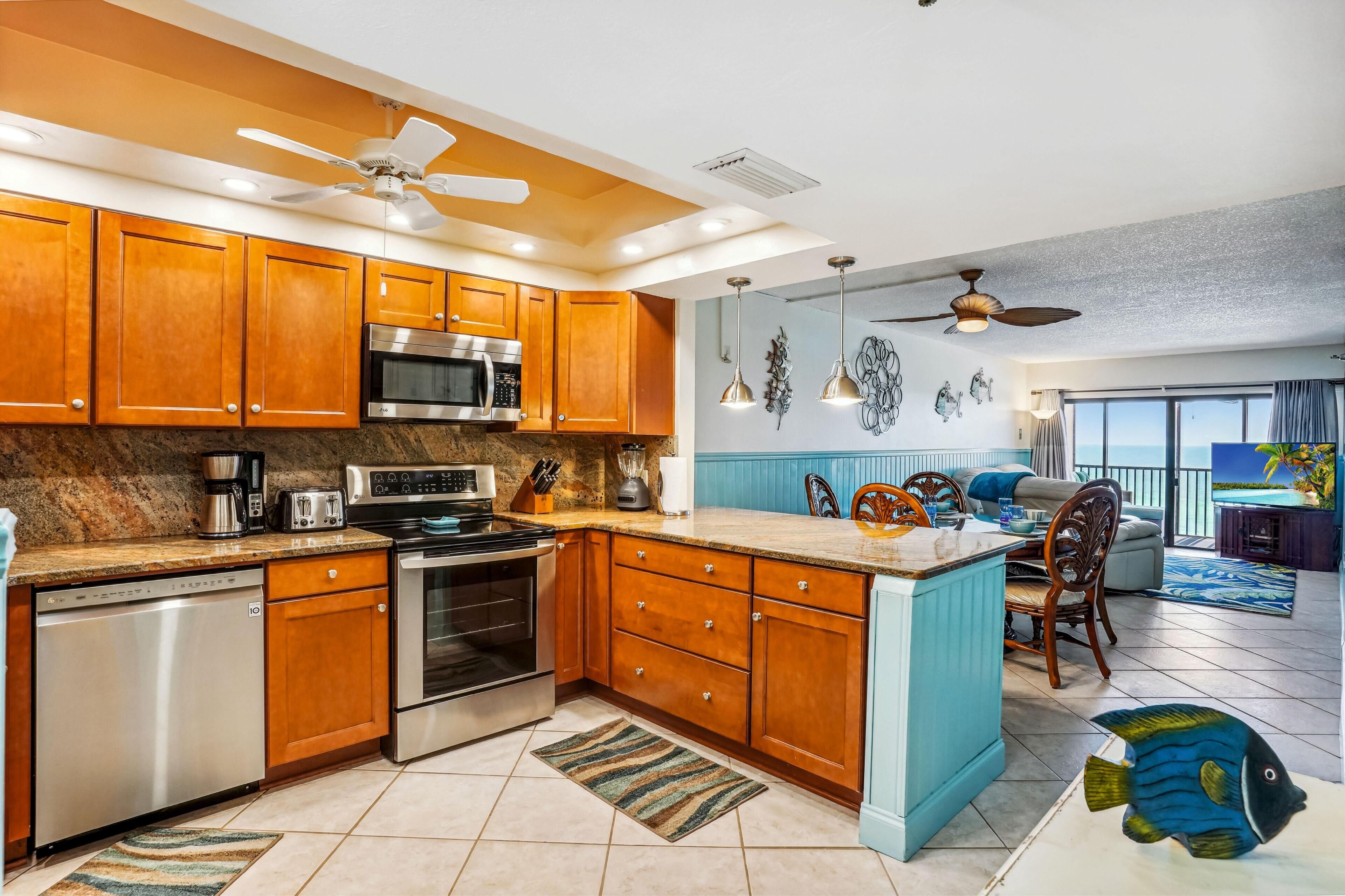 A modern kitchen with wooden cabinets, stainless steel appliances, and a central island.