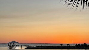 A pier extending into calm waters during sunset. - Oceanview condo in heart of PSJ Beach (Port St. Joe)