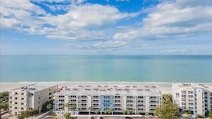 A multi-story hotel with a view of the ocean. - Holiday Villas II 407 Premier (Indian Shores)