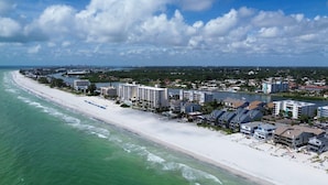 A coastal cityscape with a beach, hotels, and a river. - Pelican Pointe 3B (Indian Shores)