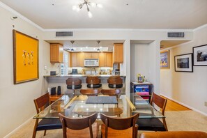 Enjoy meals in this dining area with a glass-top table and comfortable seating.