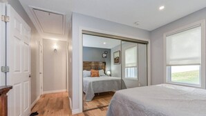 A bedroom with a large bed, a smaller bed, and a walk-in closet. - (A)  Elora Grand River Suite (Elora)