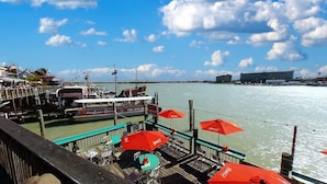 A waterfront restaurant with outdoor seating and a view of the water. - The Harbor Condo 303 - Premier (Madeira Beach)