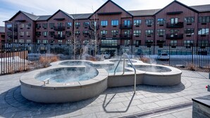A modern building with a pool area featuring a hot tub and a fountain. - Pioche Village by Park City Vacations (Park City)