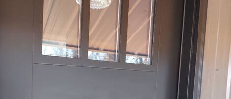 A door with a window and a keypad lock.