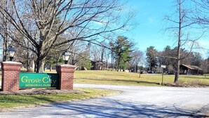 A road leading to Grove City Memorial Park with a brick entrance and a green sign. - Breckenridge Suites #6 - Cozy 1-Bedroom Suite with Fully Equipped Kitchen (Grove City)