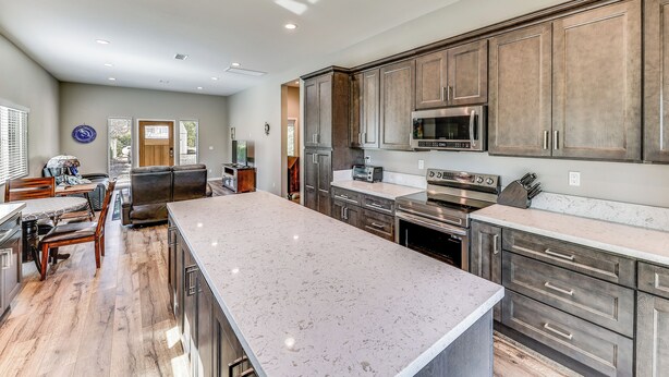 A spacious kitchen with a large island, built-in appliances, and a dining area with a table and chairs. - Peaceful Riverside Home w/ Patio, 7 Mi to Downtown (Riverside)