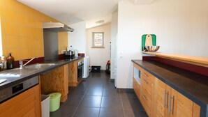 A modern kitchen with wooden cabinets, a stainless steel sink, and a built-in oven. - La Baumelle 4/6 persons (SAINT-PIERRE-DES-TRIPIERS)