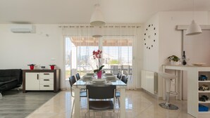 A modern dining area with a glass table, chairs, and a view of the outdoors. - Beautiful home in Vodnjan (Vodnjan)